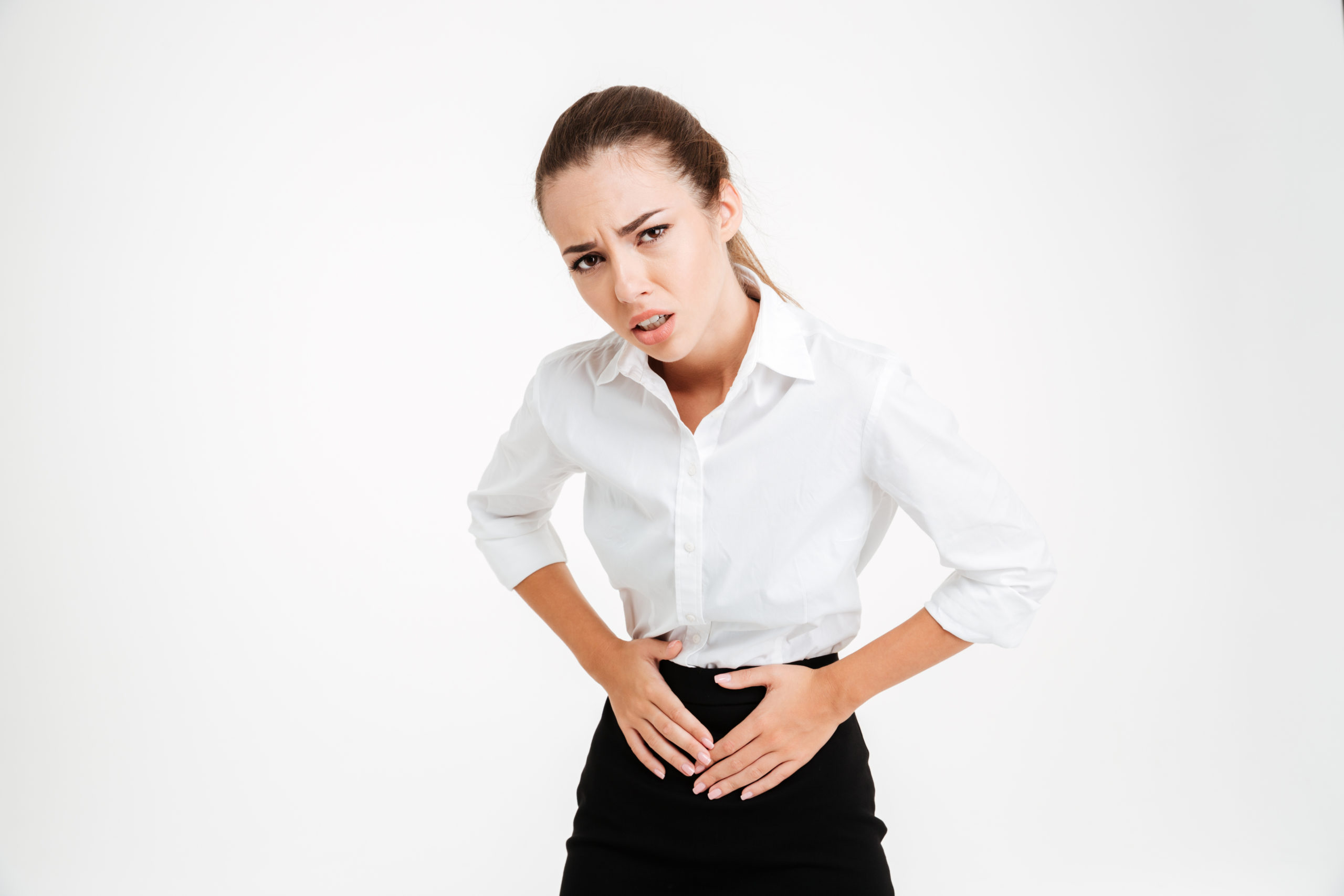 young businesswoman with stomach pain