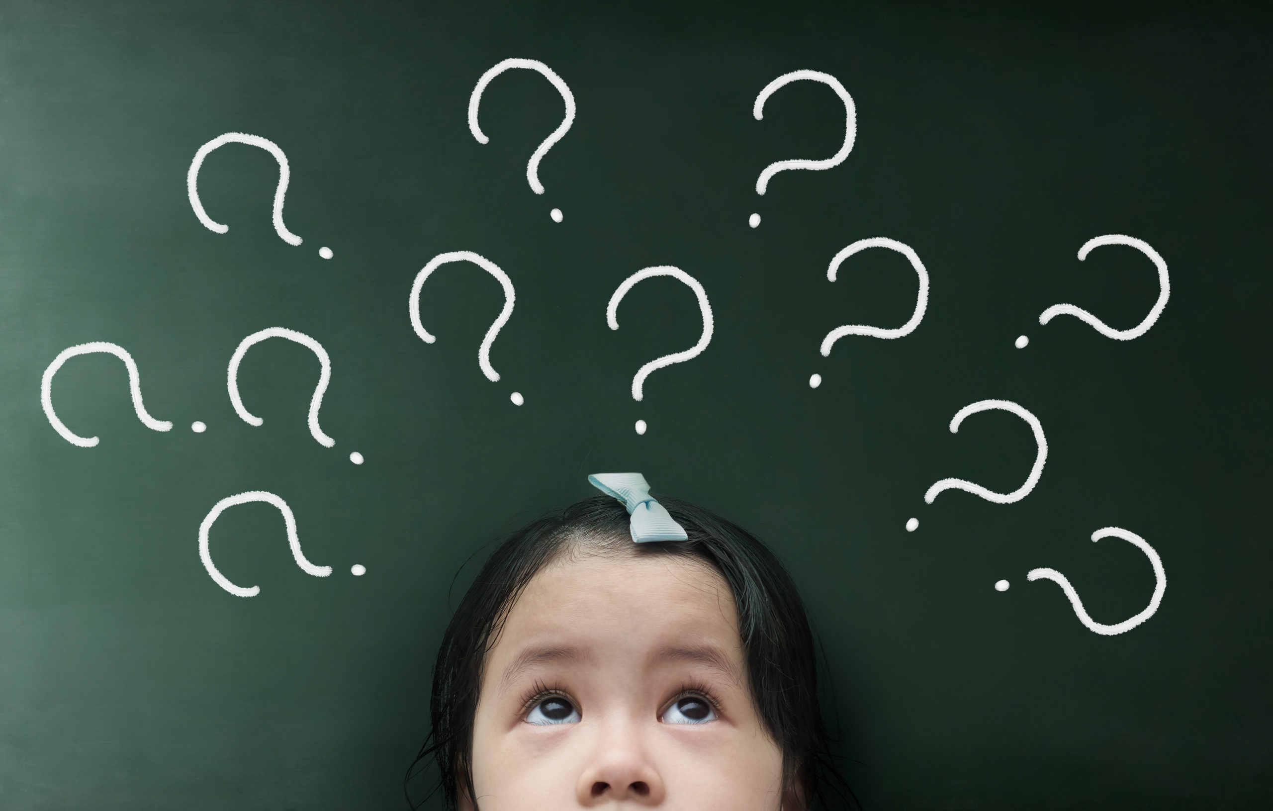 little girl thinking with question mark over her head